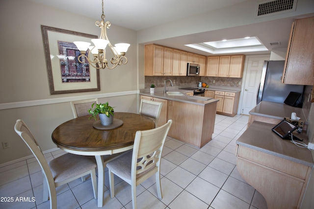 2635 N 62nd St, Mesa, AZ 85215 - kitchen with a peninsula, visible vents, light brown cabinetry, and appliances with stainless steel finishes