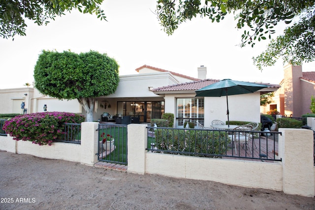 2635 N 62nd St, Mesa, AZ 85215 - mediterranean / spanish-style home with stucco siding, a tiled roof, a gate, and a fenced front yard