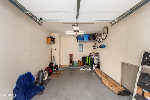 garage with electric panel and a garage door opener