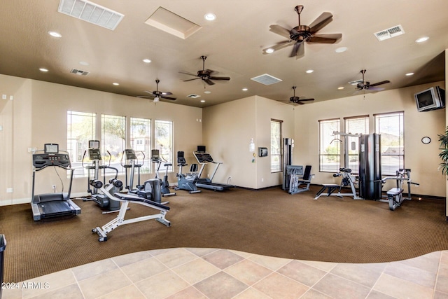 exercise room featuring ceiling fan and light tile patterned floors