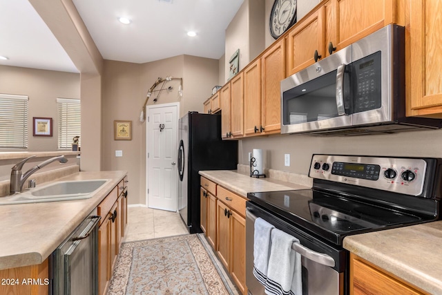 kitchen featuring sink, light tile patterned flooring, and stainless steel appliances