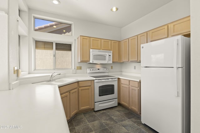 kitchen with white appliances, sink, and light brown cabinets