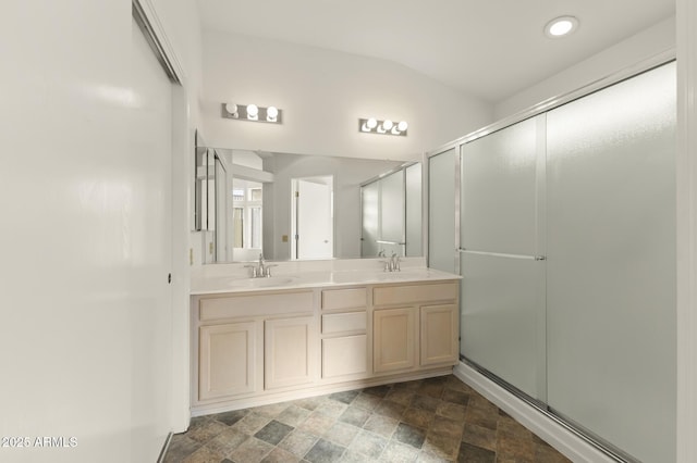 bathroom featuring walk in shower and vanity