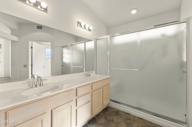 bathroom featuring an enclosed shower and vanity