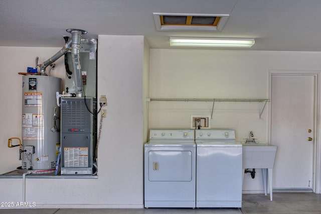 washroom with sink, washing machine and dryer, and water heater