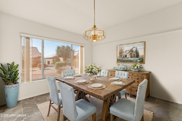 dining space featuring a notable chandelier