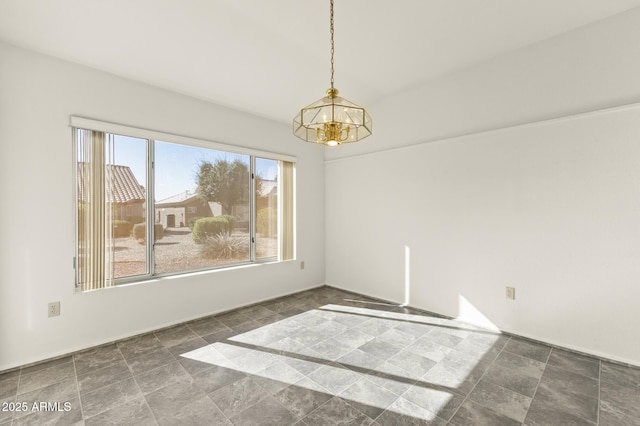 empty room featuring a chandelier