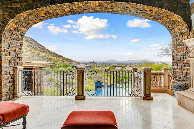 view of patio / terrace featuring a balcony and a mountain view