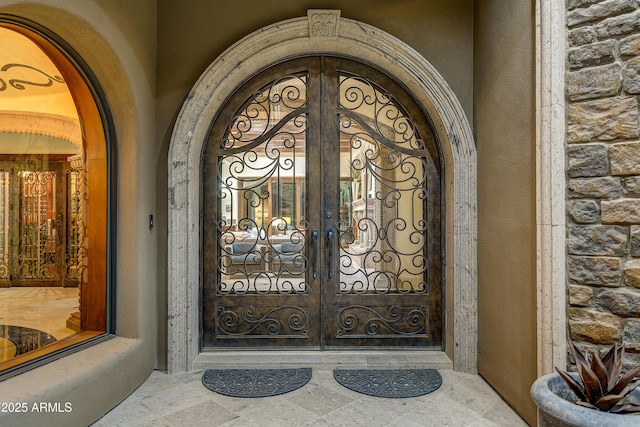 entrance to property with stone siding and french doors