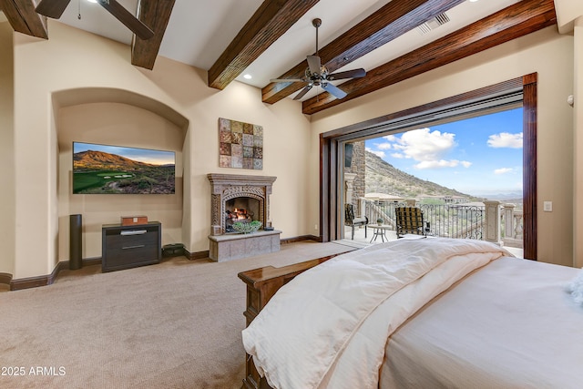 bedroom featuring beam ceiling, visible vents, carpet flooring, access to outside, and a warm lit fireplace