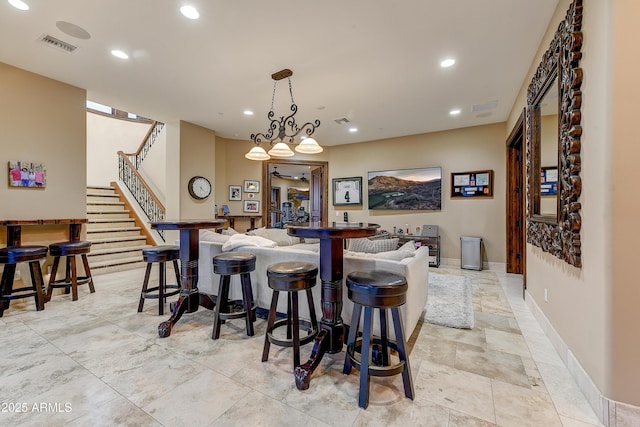 kitchen with a kitchen breakfast bar, visible vents, and recessed lighting