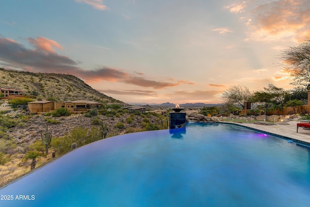 pool at dusk with a mountain view