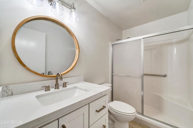 full bathroom featuring toilet, a shower stall, and vanity