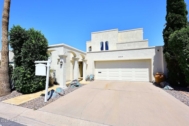 4317 N 70th St, Scottsdale, AZ 85251 - view of front of home featuring stucco siding, concrete driveway, and a garage