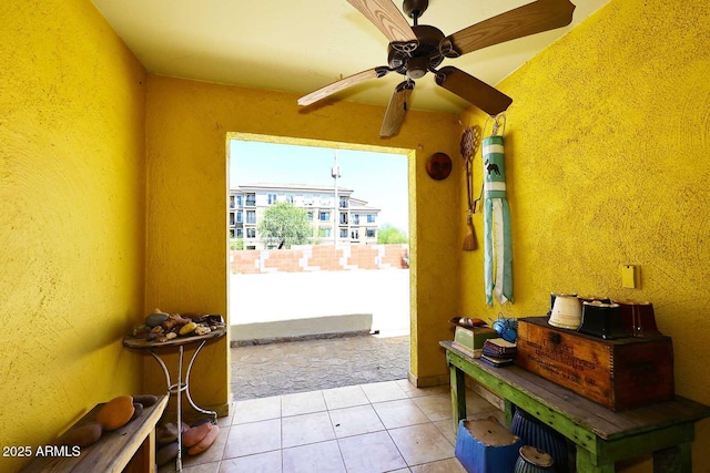 4317 N 70th St, Scottsdale, AZ 85251 - doorway to outside featuring tile patterned floors, a ceiling fan, and a textured wall