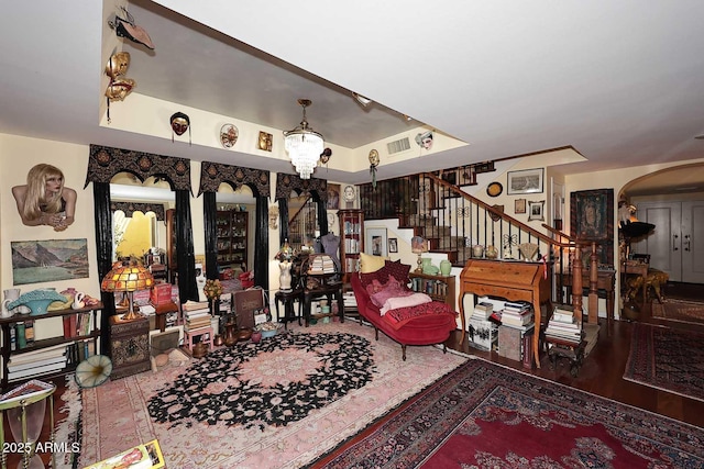 4317 N 70th St, Scottsdale, AZ 85251 - living room featuring arched walkways, stairway, and a raised ceiling