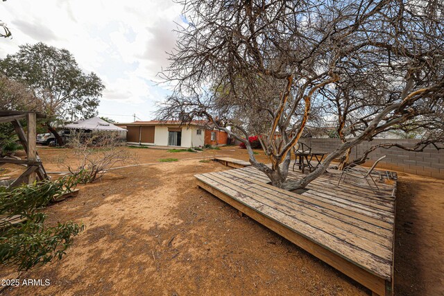 view of yard featuring a deck and fence