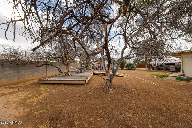 view of yard with fence and a deck