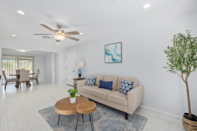 tiled living room featuring ceiling fan