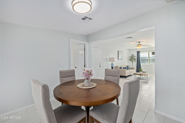 tiled dining room featuring ceiling fan