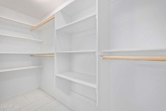 spacious closet featuring light tile flooring