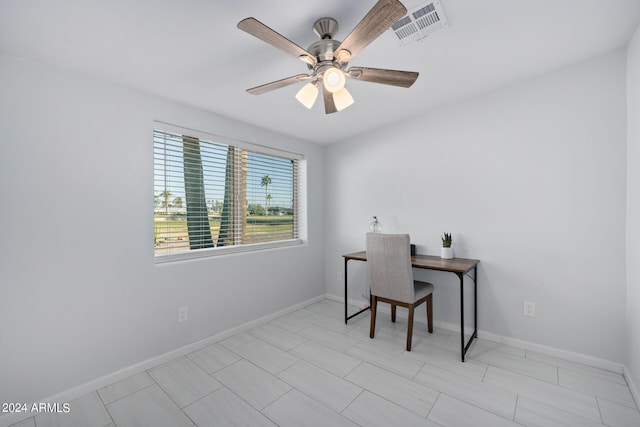 home office with light tile floors and ceiling fan