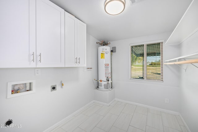 laundry room featuring gas water heater, electric dryer hookup, washer hookup, cabinets, and light tile flooring