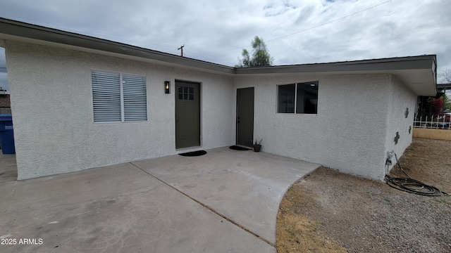 view of front of property with a patio and stucco siding