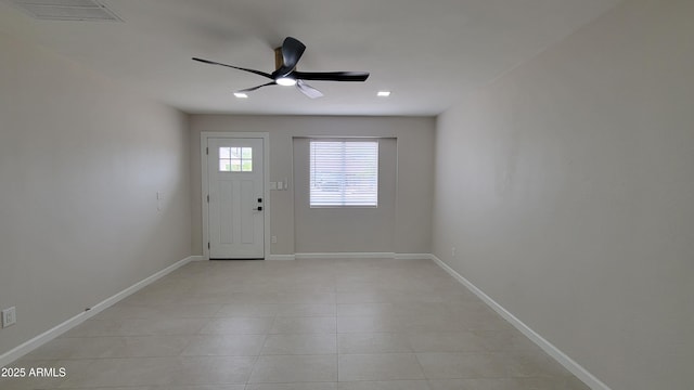 entryway featuring a ceiling fan, light tile patterned floors, and baseboards