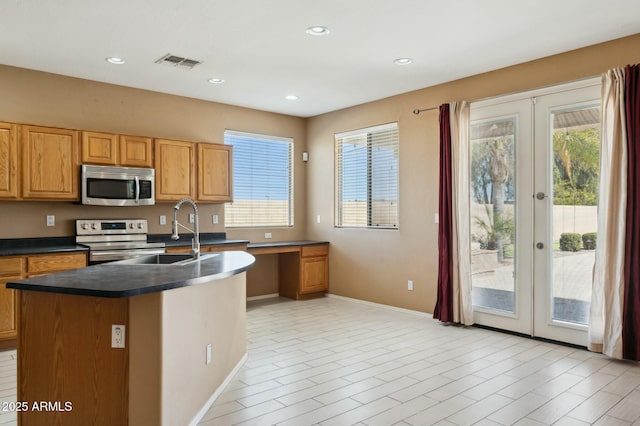 kitchen with french doors, visible vents, dark countertops, and appliances with stainless steel finishes