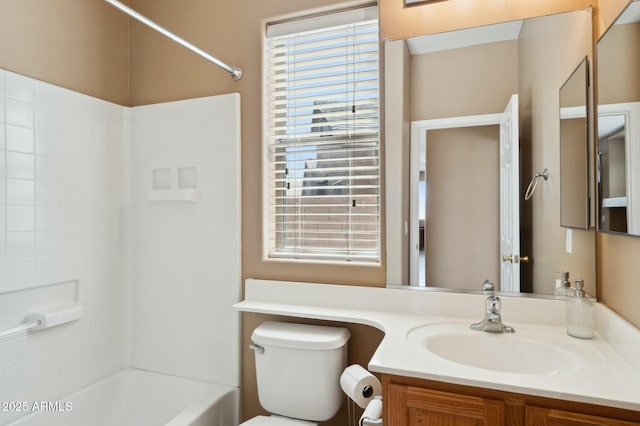 bathroom featuring toilet, shower / bathing tub combination, and vanity
