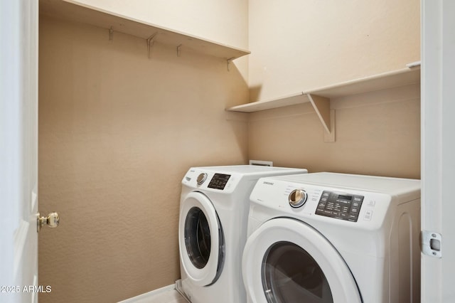 washroom with washing machine and clothes dryer and laundry area