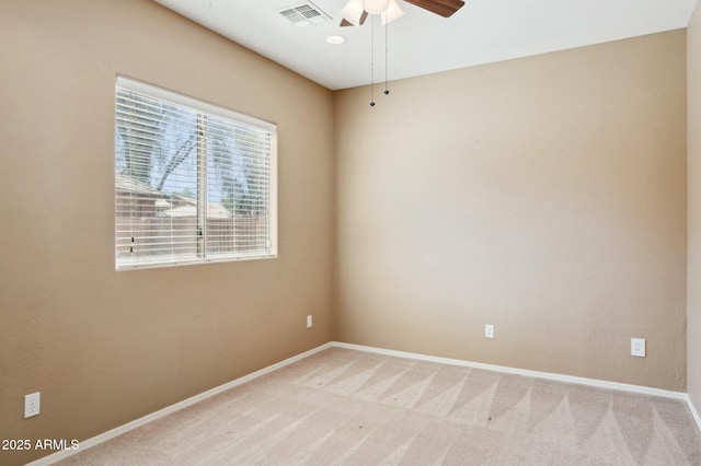 spare room featuring baseboards, visible vents, ceiling fan, and carpet floors