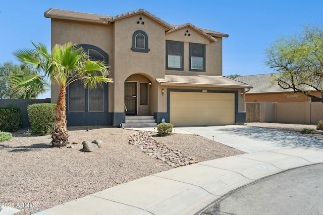 mediterranean / spanish home with driveway, fence, an attached garage, a tile roof, and stucco siding