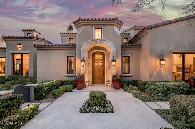 view of exterior entry at dusk