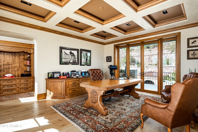 home office with beam ceiling, coffered ceiling, crown molding, and light hardwood / wood-style floors