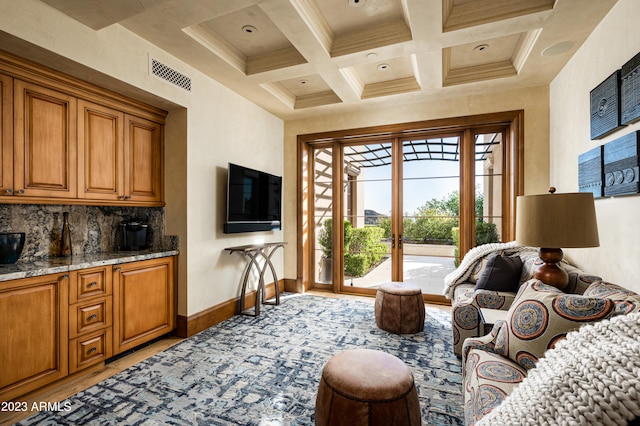 interior space with crown molding, coffered ceiling, access to outside, and beamed ceiling