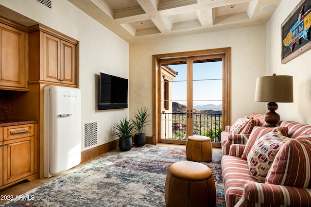 living room featuring beamed ceiling, coffered ceiling, crown molding, and light tile patterned floors