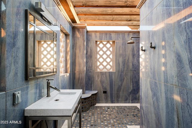 bathroom featuring sink and tile walls