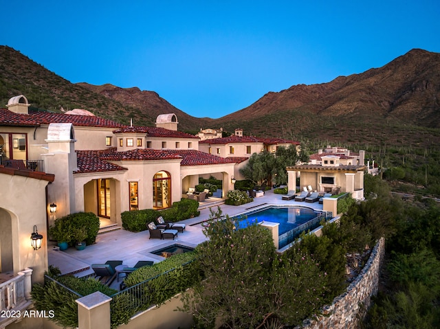 view of swimming pool with a mountain view and a patio