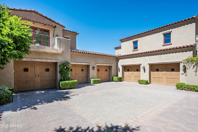 mediterranean / spanish home with a garage