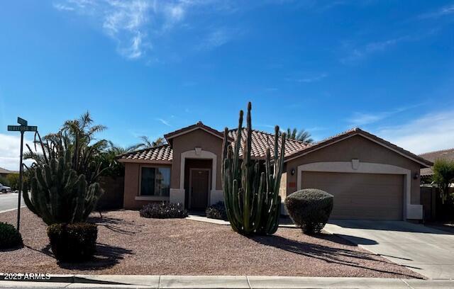 553 W Hereford Dr, San Tan Valley, AZ 85143 - view of front of house featuring a tiled roof, a garage, driveway, and stucco siding