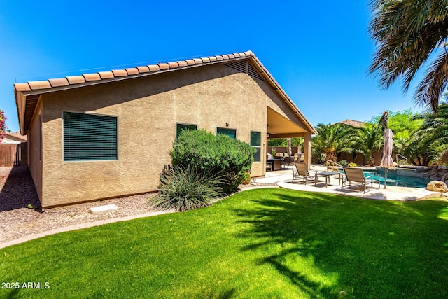 553 W Hereford Dr, San Tan Valley, AZ 85143 - rear view of house with fence, a tiled roof, a yard, stucco siding, and a patio area