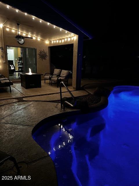 553 W Hereford Dr, San Tan Valley, AZ 85143 - pool at night with a patio area, an outdoor pool, and an outdoor fire pit