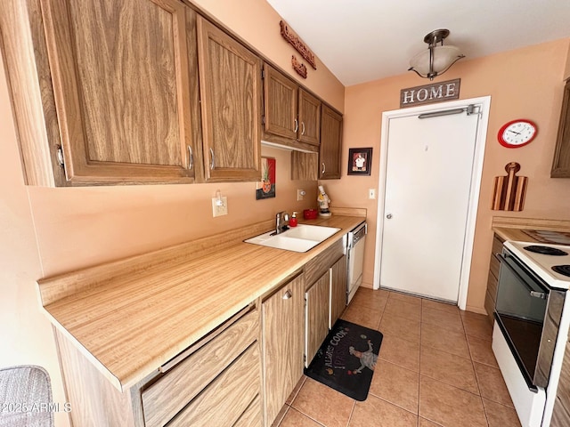 kitchen with sink, white electric range, stainless steel dishwasher, and light tile patterned floors