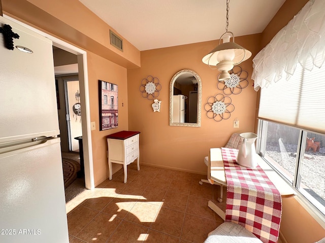 interior space featuring dark tile patterned floors and white fridge