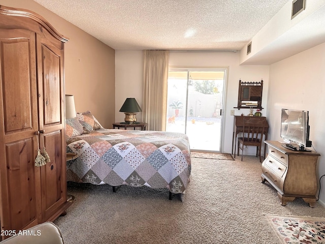 bedroom featuring carpet flooring, access to outside, and a textured ceiling