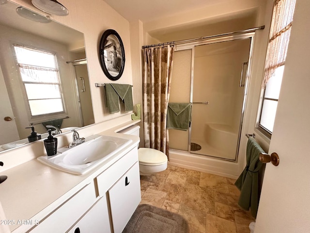 bathroom with a shower, vanity, and toilet