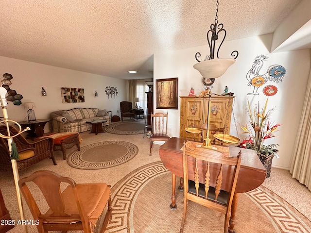 dining area with carpet floors and a textured ceiling