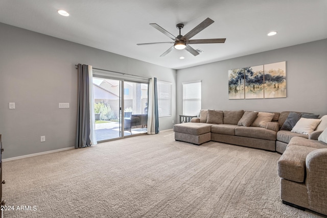 carpeted living room featuring ceiling fan